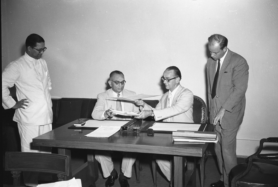 Ph. Studio/June, 1957, A22n/A22a(iv) Photo shows Shri H.M. Patel, Secretary Ministry of Finance (left) and H.E. Mr. Aaro Pakaslahti Head of the Finish Legation in India, who signed the agreement on behalf of their respective Governments, exchanging the Agreement papers, in New Delhi on June 14, 1957.